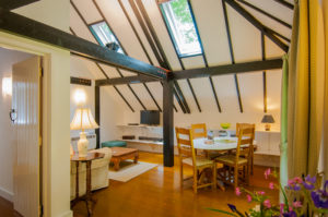 Dining and sitting areas of the holiday cottage with flatscreen TV and wifi, sofa and dining table and chairs