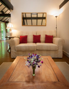The sitting room with sofa and coffee table in All Saints Cottage, a rental accommodation near Pewsey, Wiltshire