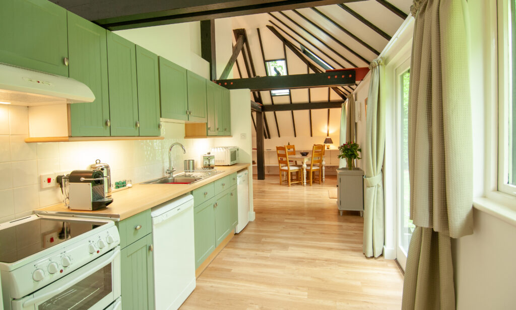 Kitchen leading to dining area in a Wiltshire holiday cottage, fully equipped kitchen including Nespresso machine